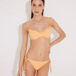 Front View: Model in Luigiana Orange Bikini Bottom - MOEVA Luxury Swimwear, Low Waist, Side-Tie, Gold Stopper, Stitching Details, Moderate Bottom Coverage, MOEVA Luxury Swimwear  