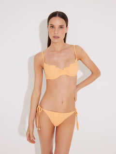 Front View: Model in Luigiana Orange Bikini Bottom - MOEVA Luxury Swimwear, Low Waist, Side-Tie, Gold Stopper, Stitching Details, Moderate Bottom Coverage, MOEVA Luxury Swimwear  