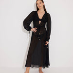 "Front view of a model wearing the Lula Black Maxi Dress, showcasing its classic silhouette and blouson sleeves."