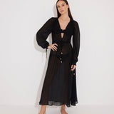 "Front view of a model wearing the Lula Black Maxi Dress, showcasing its classic silhouette and blouson sleeves."