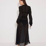 "Back view of the Lula Black Maxi Dress, highlighting the deep v-neckline and sheer silk fabric."