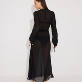 "Back view of the Lula Black Maxi Dress, highlighting the deep v-neckline and sheer silk fabric."