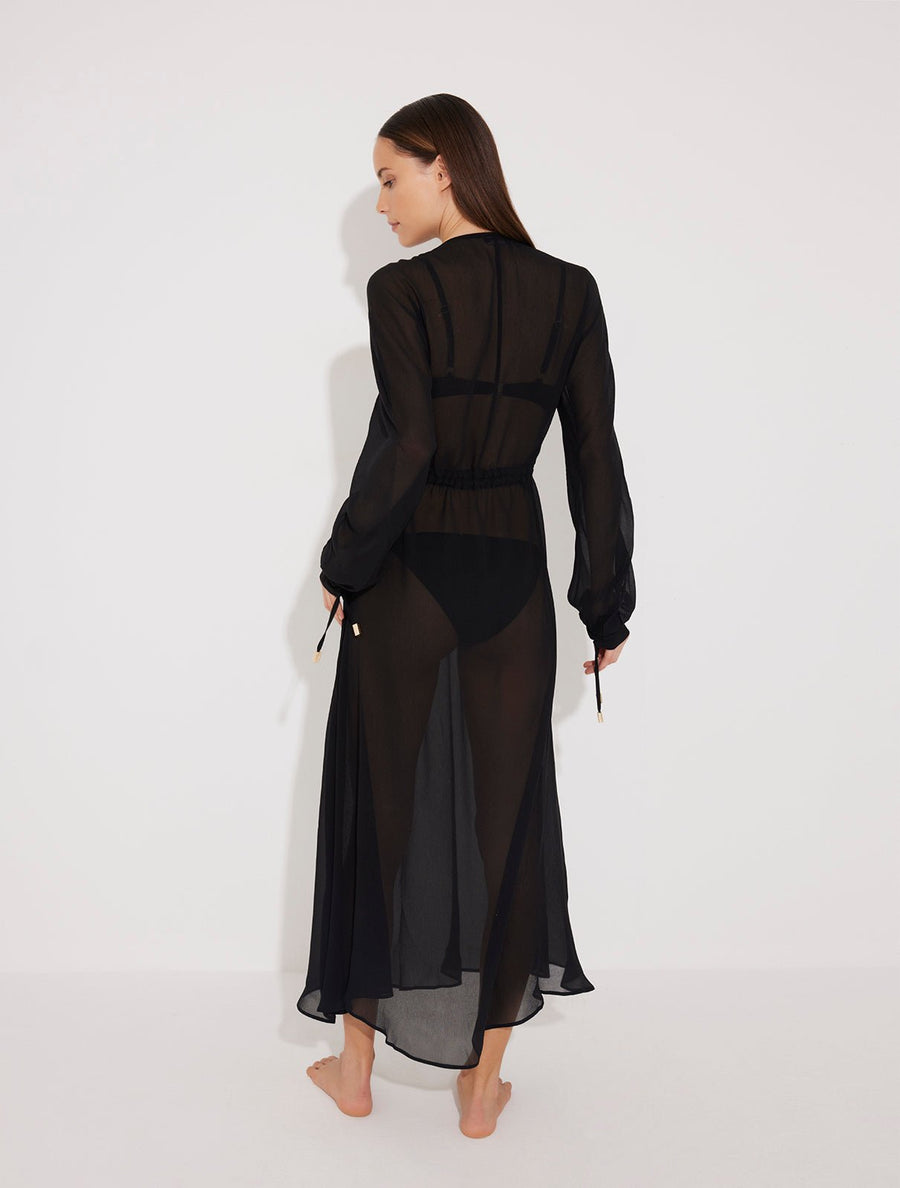 Back View: Model in Lula Black Dress - MOEVA Luxury Swimwear, Ankle Length, Loose Fit, Silk V Neck Silk Beach Dress, MOEVA Luxury Swimwear