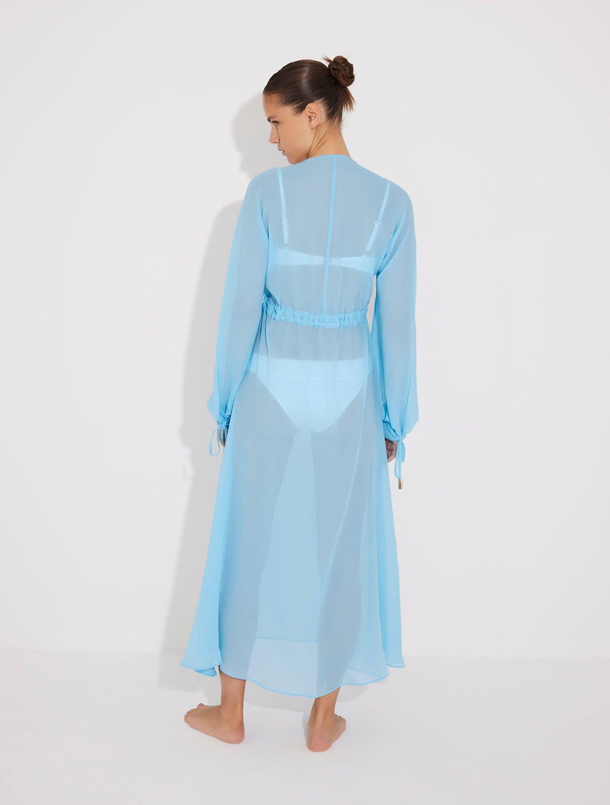 "Bacl view of the Lula Blue Silk Dress on a model, emphasizing its loose fit and adjustable neckline."