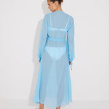 "Bacl view of the Lula Blue Silk Dress on a model, emphasizing its loose fit and adjustable neckline."