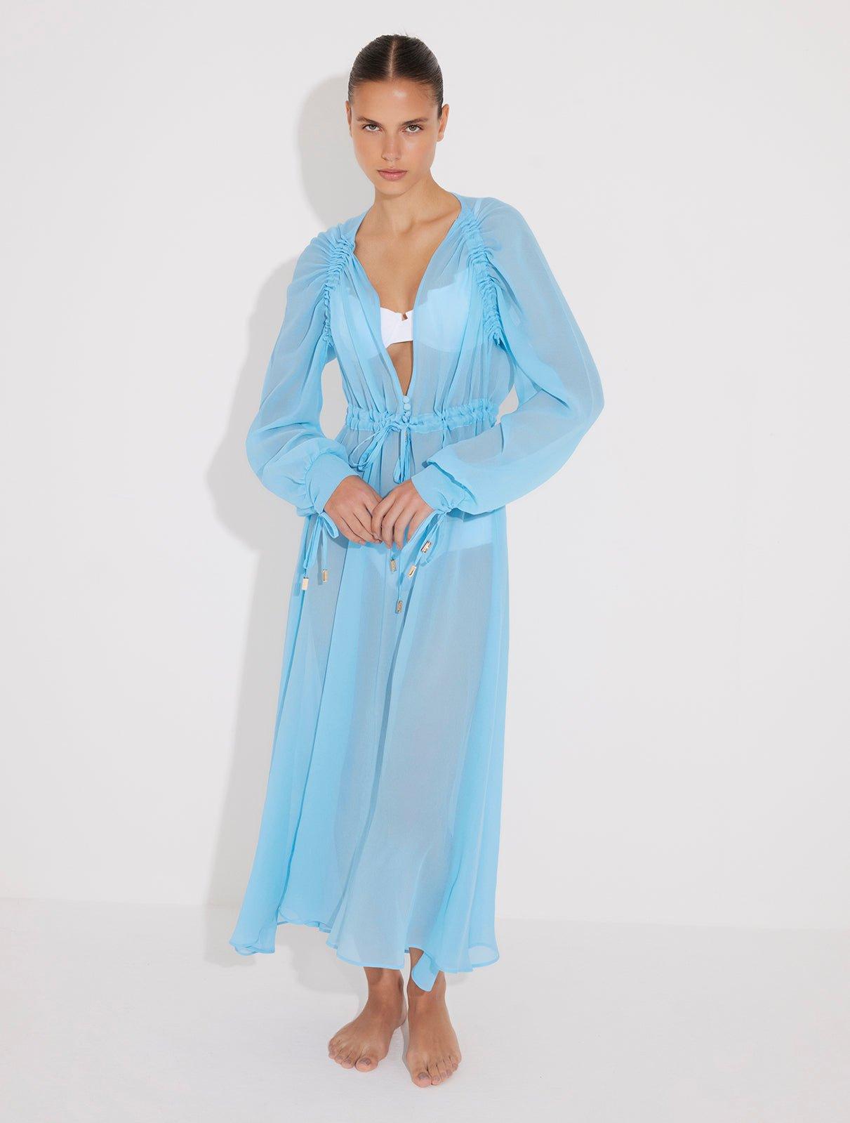 "Front view of a model wearing the Lula Blue Maxi Dress, showcasing its classic silhouette and blouson sleeves."