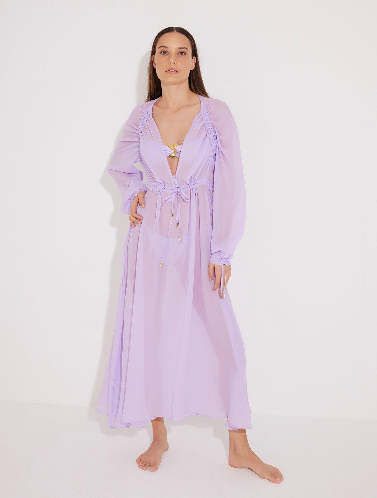 "Front view of a model wearing the Lula Lilac Maxi Dress, showcasing its classic silhouette and blouson sleeves."