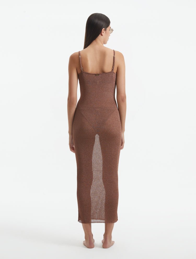 Back View: Model in Lulusar Brown Dress - MOEVA Luxury Swimwear, Adjustable Straps, Ankle Length, Close Fit, Chic and Comfort Knitted Metallic Maxi Dress, MOEVA Luxury Swimwear