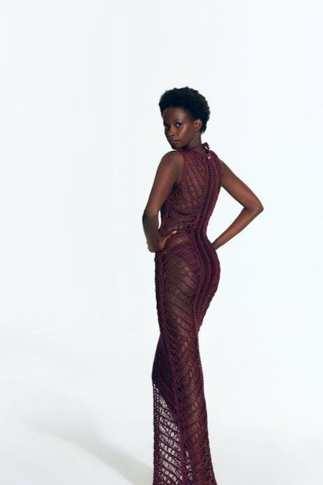 "Back view of Luna Prune Dress displaying intricate crochet pattern."