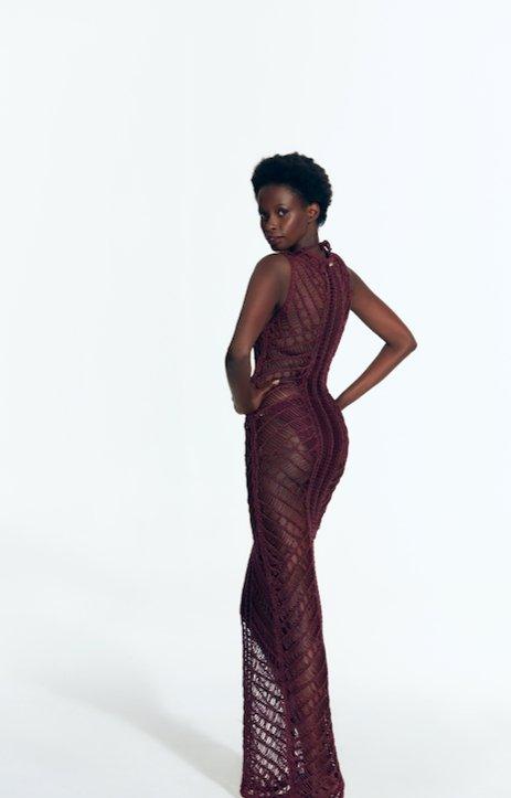"Back view of Luna Prune Dress displaying intricate crochet pattern."