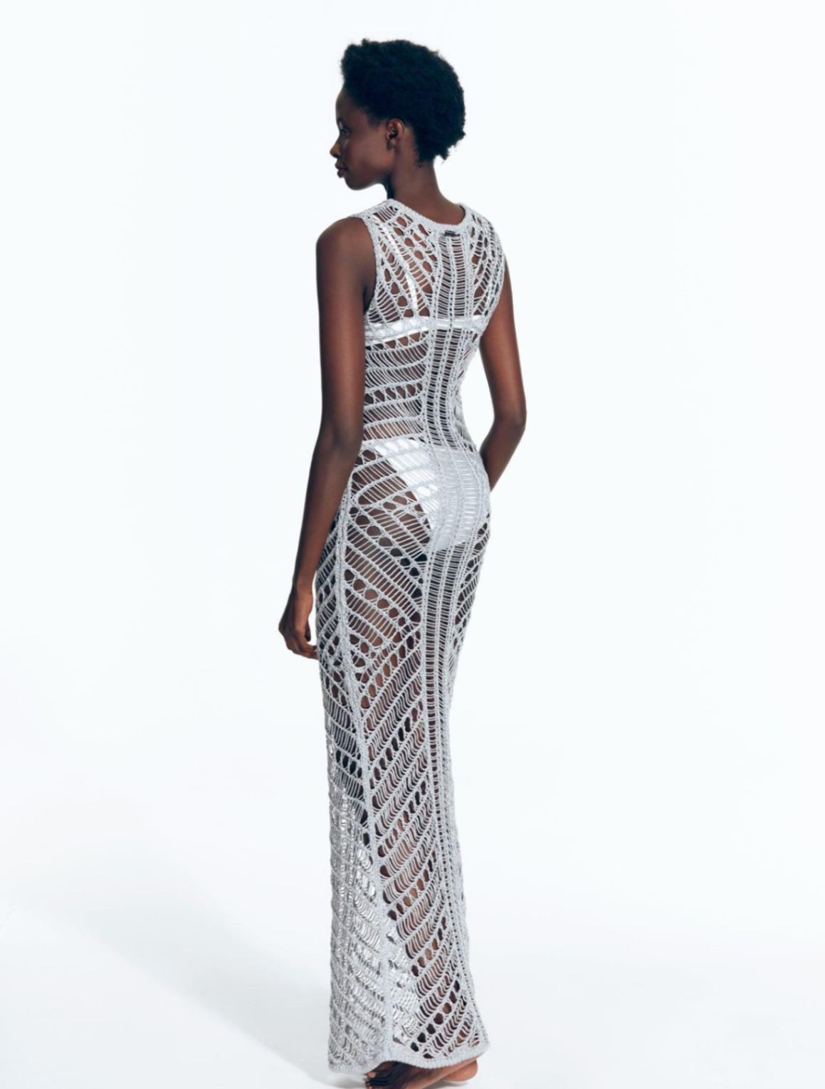 "Back view of Luna Silver Dress displaying intricate crochet pattern."