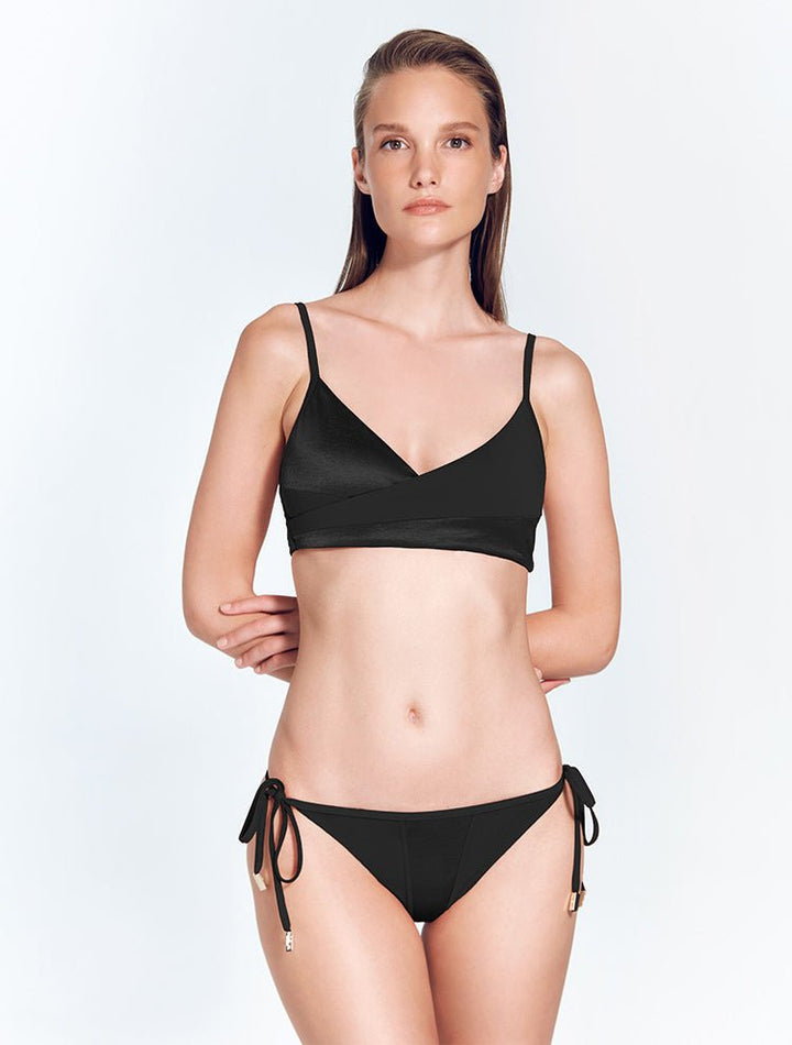 Front View: Model in Maelys Black Bikini Bottom - Satin Matte Contrast, Low Rise, Straps Ties at the Side, Moderate Coverage, MOEVA Luxury Swimwear