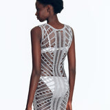 "Model wearing Maggie Silver Dress from the back view. The dress features a scoop neckline, body-firming crochet fabric,"