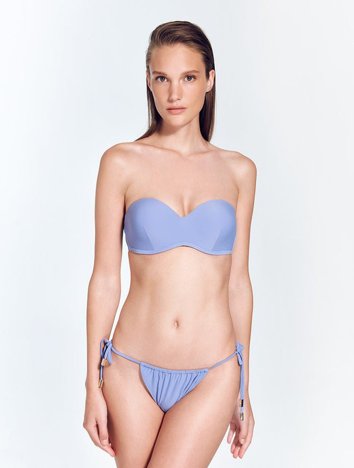 Front View: Model in Maissa Blue Bikini Bottom - Brazilian Bottom, Low Rise, Straps Ties at the Side, Comfort, Soft Touch Fabric MOEVA Luxury Swimwear