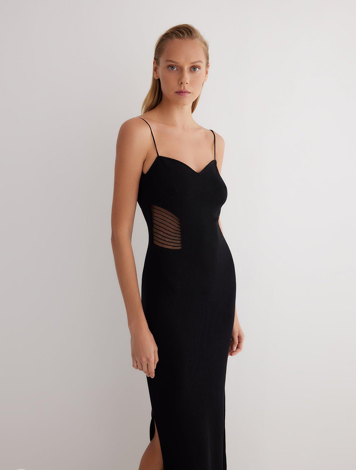 "Front view of the Malin black ankle-length dress showcasing the close fit, scoop neckline, and semi-sheer panels."