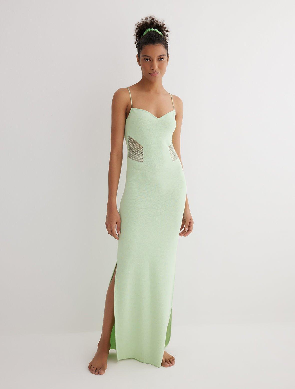 "Front view of the Malin mint green ankle-length dress showcasing the close fit, scoop neckline, and semi-sheer panels."