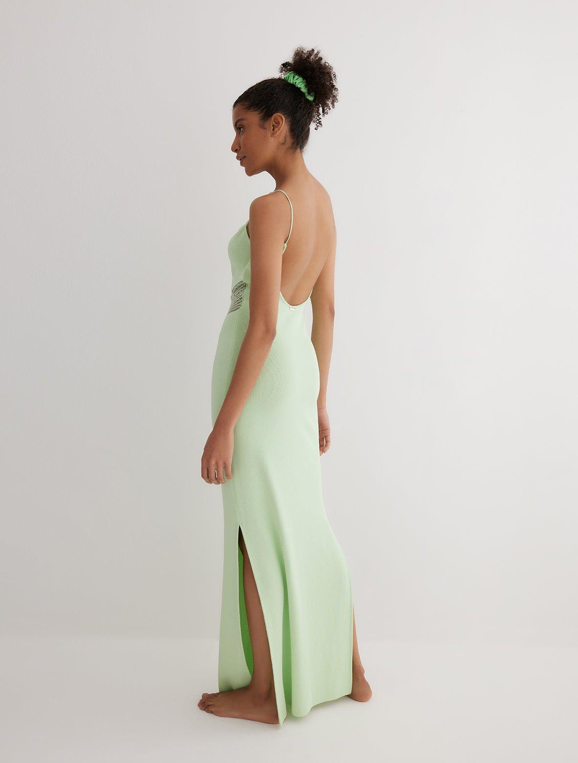 "Back view of the Malin mint green dress, emphasizing the sleek fit and knitted design."