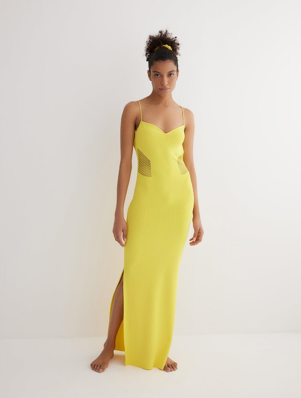 "Front view of the Malin yellow ankle-length dress showcasing the close fit, scoop neckline, and semi-sheer panels."