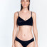 "Front view of the Manon Black Bikini Bottom, showing the low-rise waist and ruched satin side straps."