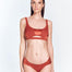 " Front view of the Manon Red Ochre Bikini Bottom, highlighting the low-rise waist, small coverage, and ruched satin side straps."