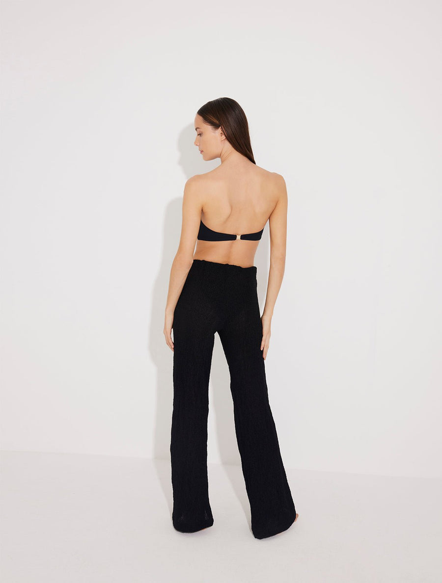 Back View: Model in Manuela Black Pants - MOEVA Luxury Swimwear, Unlined, Comfort, Accessorised, Recycle Fabric High Rise Beach Pants, MOEVA Luxury Swimwear