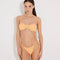 Front View: Model in Marcella Orange Bikini Top - Bandeau Style, Twisted Gold Accessory Detail, Ruched Detailing, Removable Padding and Straps, MOEVA Luxury Swimwear  