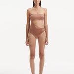  Model showcasing the Marilla Brown Swimsuit, highlighting the high-waist style and strapless design with cut-out detail.