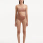  Model showcasing the Marilla Brown Swimsuit, highlighting the high-waist style and strapless design with cut-out detail.