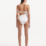 Back view of the Marilla White Swimsuit, emphasizing the gold clasps and overall fit.