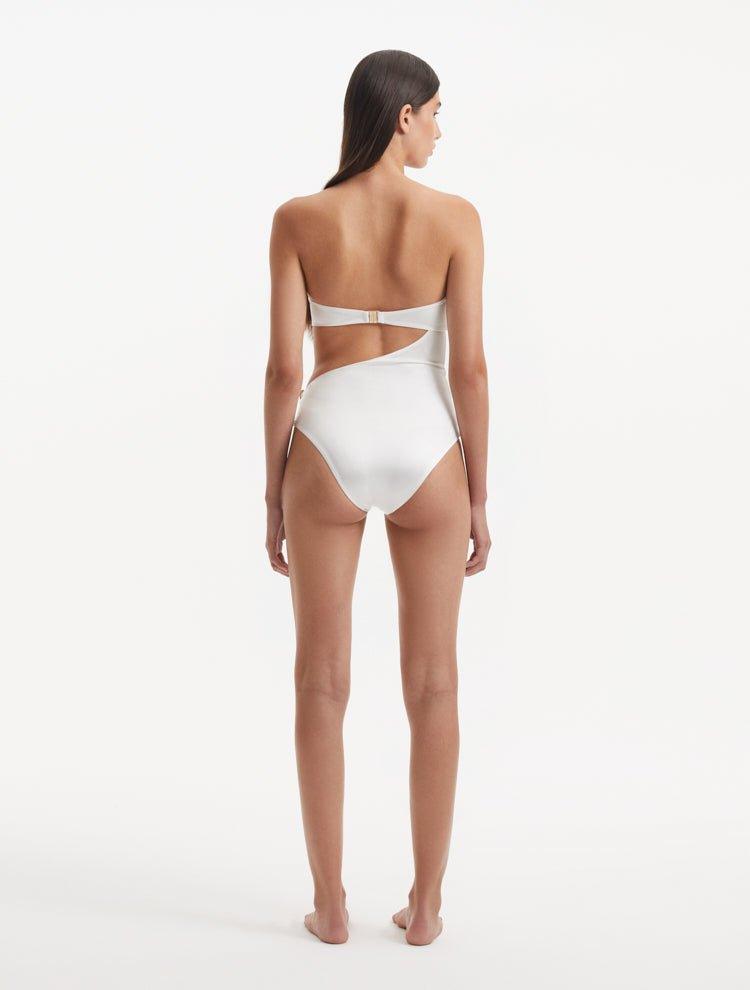 Back view of the Marilla White Swimsuit, emphasizing the gold clasps and overall fit.