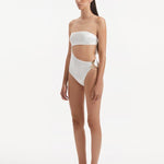  Side view of the Marilla White Swimsuit, showcasing the high-waist silhouette and strapless design.