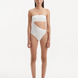 Model showcasing the Marilla White Swimsuit, highlighting the high-waist style and strapless design with cut-out detail.