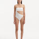 Model showcasing the Marilla White Swimsuit, highlighting the high-waist style and strapless design with cut-out detail.