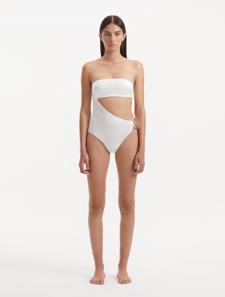 Model showcasing the Marilla White Swimsuit, highlighting the high-waist style and strapless design with cut-out detail.