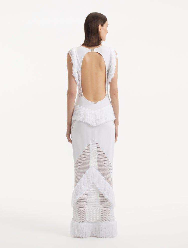 "Maris White Dress from the back, focusing on the low back cut adorned with sparkling gold clasps. "