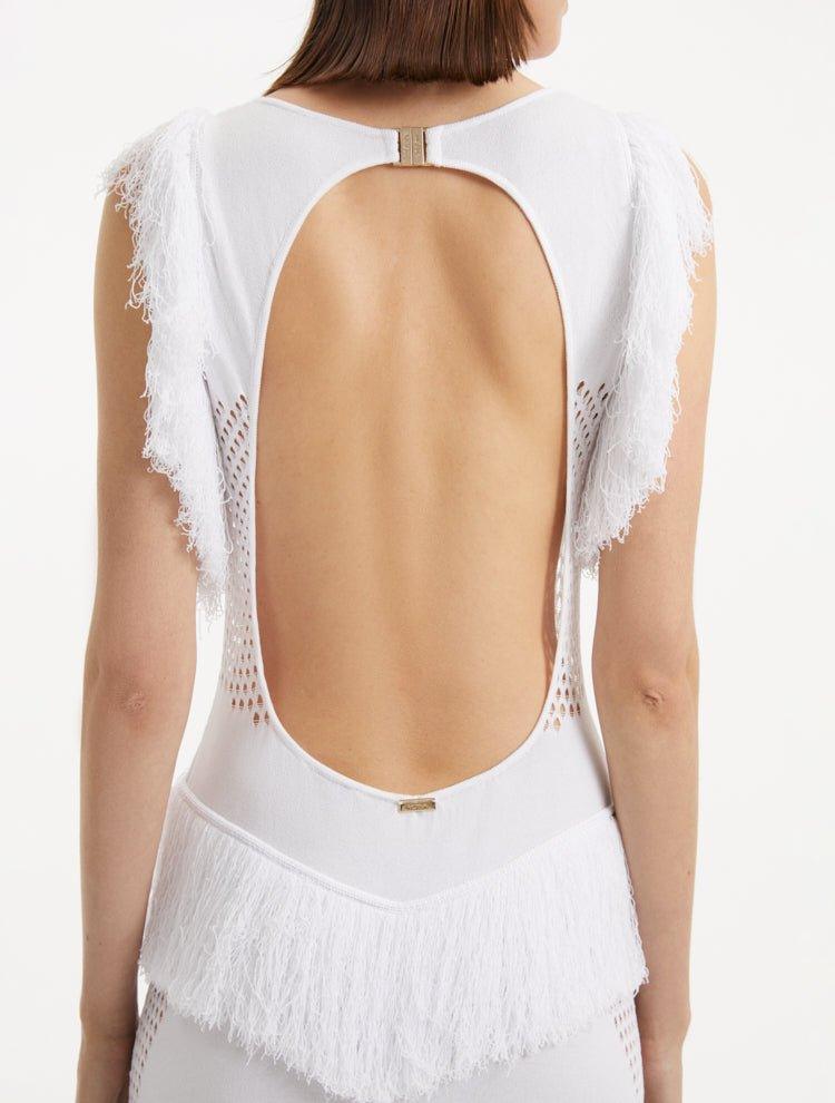 " Close-up of the Maris White Dress, capturing the texture of the mesh knit, the gold clasps, and the fringes at the hem."