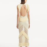 "Maris Yellow Dress from the back, focusing on the low back design adorned with golden clasps. "