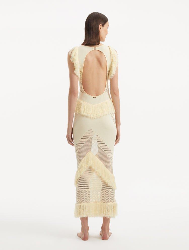 "Maris Yellow Dress from the back, focusing on the low back design adorned with golden clasps. "