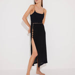 Front View: Model in Maritza Black Skirt - MOEVA Luxury Swimwear, Side Slit, High Rise, Elastic Waistband, Geometrical Chain Belt, MOEVA Luxury Swimwear
