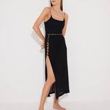 Front View: Model in Maritza Black Skirt - MOEVA Luxury Swimwear, Side Slit, High Rise, Elastic Waistband, Geometrical Chain Belt, MOEVA Luxury Swimwear