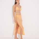 Front View: Model in Maritza Orange Skirt - MOEVA Luxury Swimwear, Side Slit, High Rise, Elastic Waistband, Geometrical Chain Belt, MOEVA Luxury Swimwear