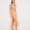 Front View: Model in Maritza Orange Skirt - MOEVA Luxury Swimwear, Side Slit, High Rise, Elastic Waistband, Geometrical Chain Belt, MOEVA Luxury Swimwear