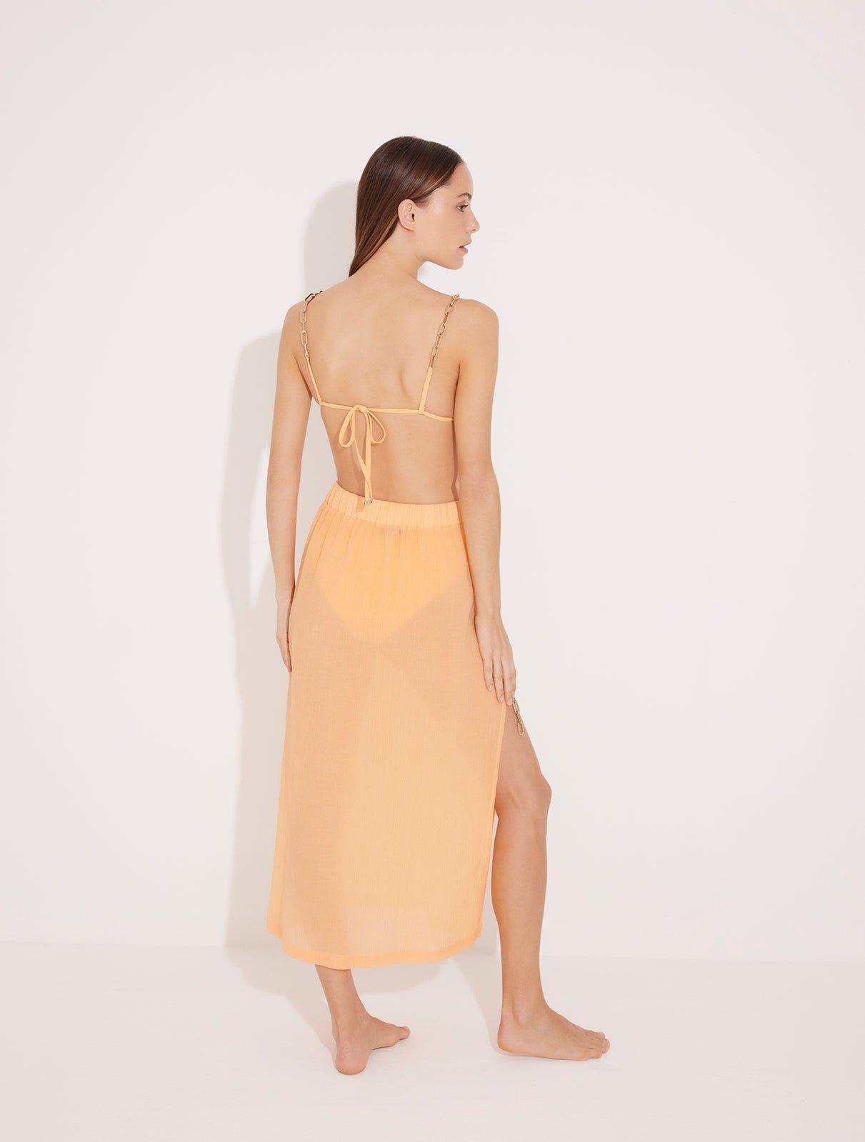 Back View: Model in Maritza Orange Skirt - MOEVA Luxury Swimwear, Maxi Skirt, Unlined,Chic, Accessorised, Soft Touch Fabric, High Rise Ankle Length Beachwear, MOEVA Luxury Swimwear