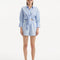 "Model wearing the Hanson Baby Blue Shirt and Masha Short from the front, showcasing its slim fit, full-length sleeves, and buttoned cuffs. The serene baby blue hue adds a soft, elegant touch, highlighting the shirt's minimalist design and premium linen fabric."