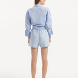 " Model wearing the Hanson Baby Blue Shirt from the back, revealing the smooth, tailored silhouette. 