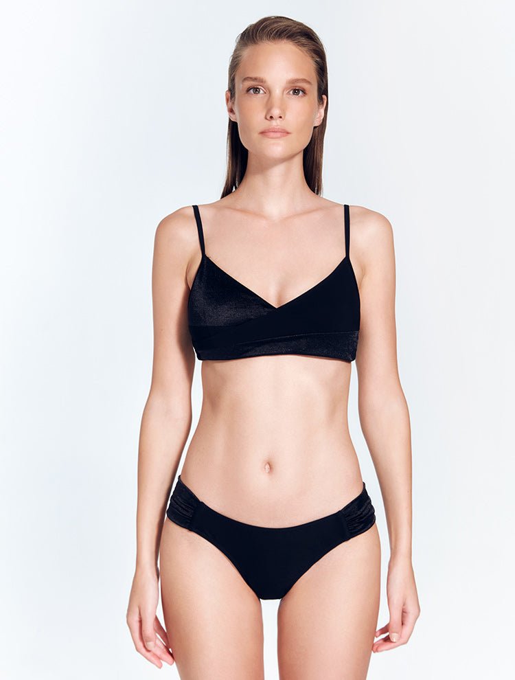 Front View: Model in Melody Black Bikini Top - MOEVA Luxury Swimwear, V Neck, Wrap-Effect Top, Matte Satin Contrast, Adjustable Straps, MOEVA Luxury Swimwear