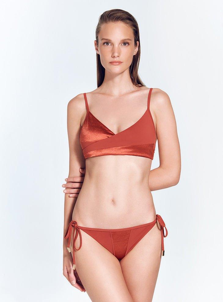 "Model wearing Melody Red Ochre Bikini Top – Front view highlighting V neckline and contrasting fabrics."