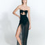  "Front view of a model wearing a black skirt with ruched detailing and a front slit. "