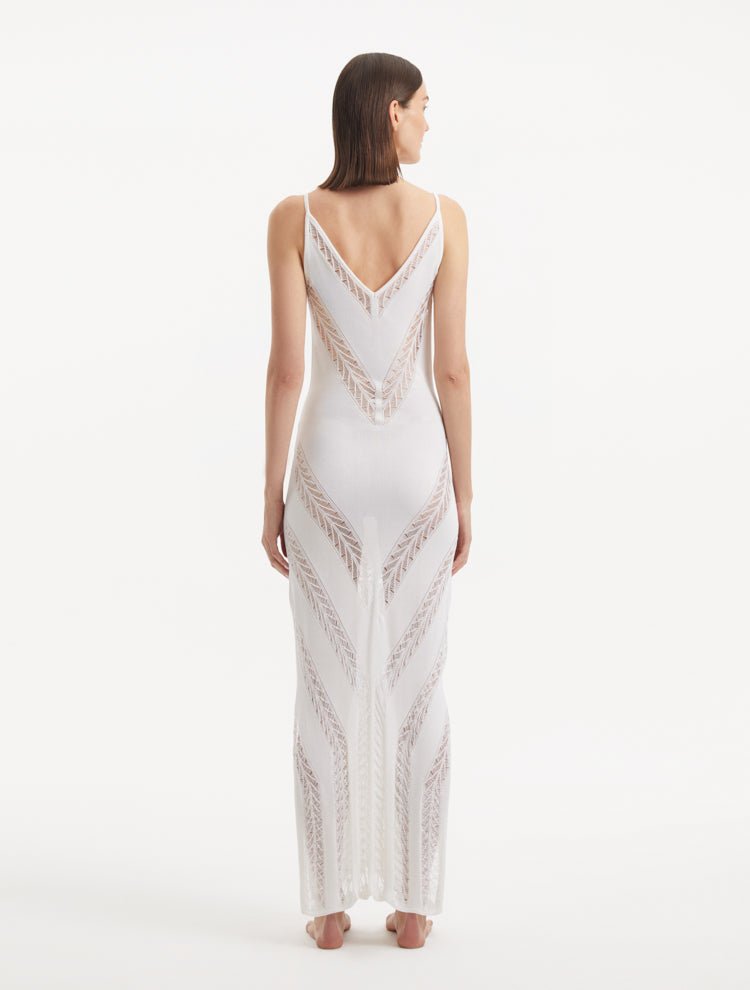 Back View: Model in Mimi White Dress - MOEVA Luxury Swimwear, Slit Details, Close Fit, MOEVA Luxury Swimwear