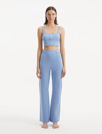 "Model wearing the Murphy Baby Blue Top and Moira Pants from the front, showcasing the high-waisted design and wide-leg silhouette. "